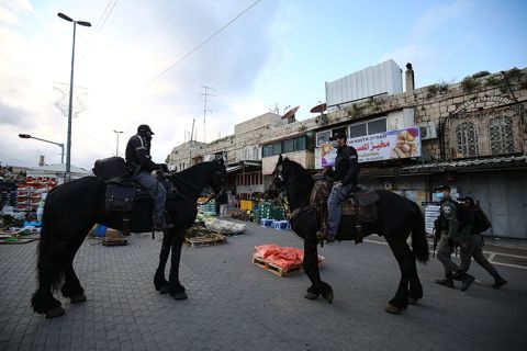 Mounted Israeli security forces patrol at a market due to restrictions imposed as measures against the novel coronavirus in Jerusalem on April 25.