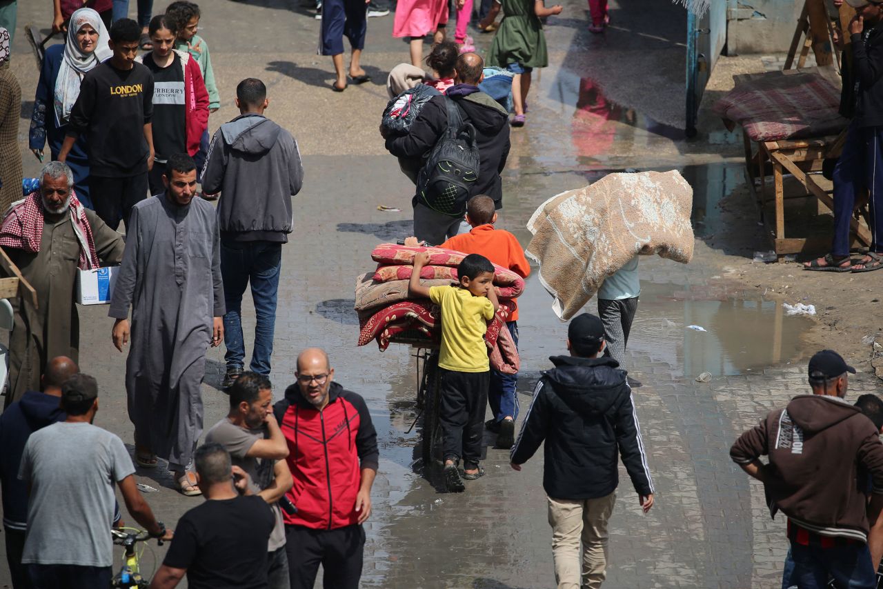 Displaced Palestinians carry their belongings as they leave Rafah following an evacuation order issued by the Israeli military on May 6.