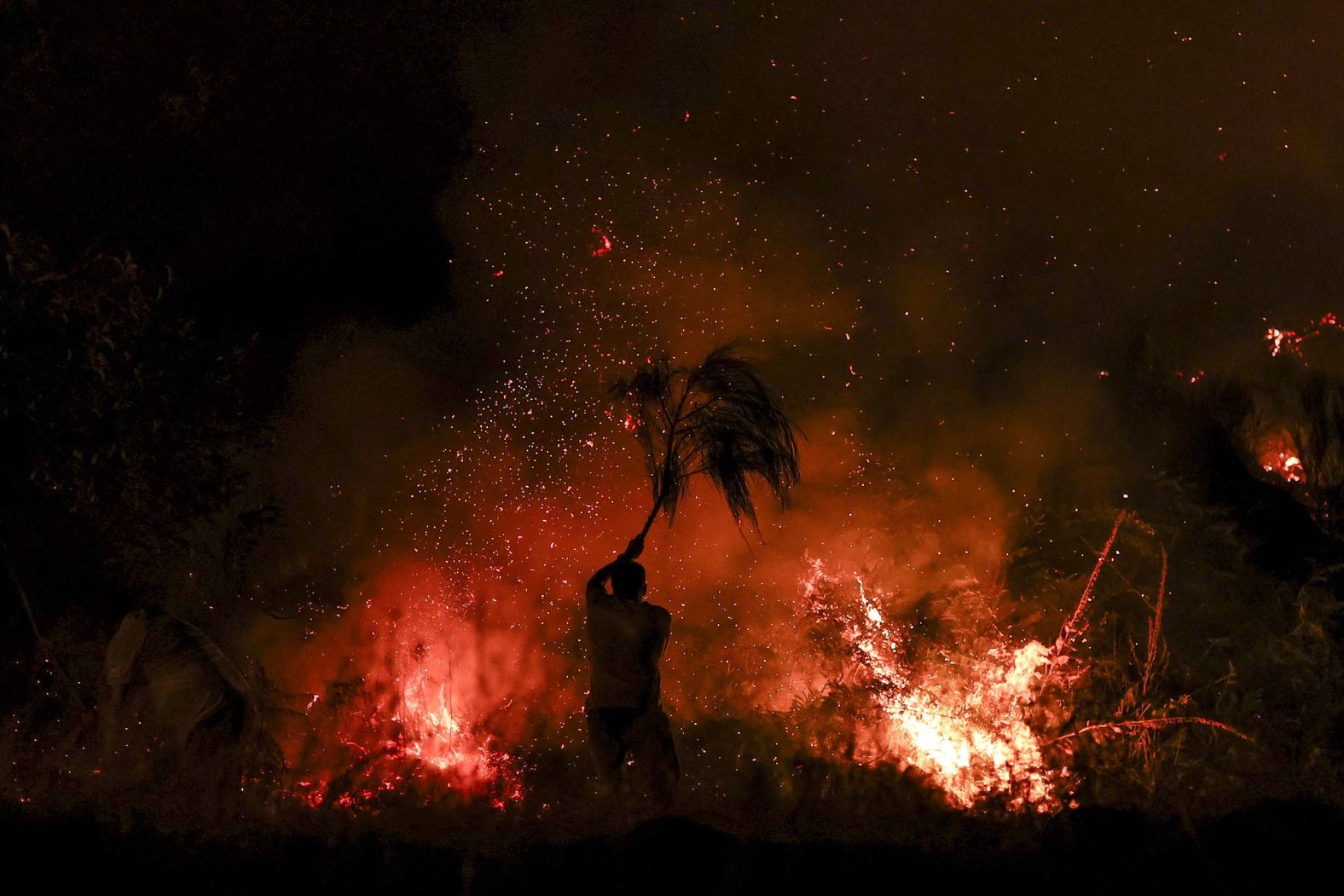 A man tries to extinguish a wildfire with a tree branch in Trancoso, Portugal, on Tuesday, August 12. Europe is on track for its <a href="index.php?page=&url=https%3A%2F%2Fwww.cnn.com%2F2025%2F08%2F12%2Fclimate%2Feurope-wildfires-heatwave-drought">worst wildfire season on record</a> as swaths of the continent — including Portugal, France, Spain, Albania and Greece — battle raging, deadly fires <a href="index.php?page=&url=https%3A%2F%2Fwww.cnn.com%2F2025%2F07%2F01%2Fweather%2Feurope-heat-wave-global-warming">as temperature soar above 100 degrees Fahrenheit</a>.