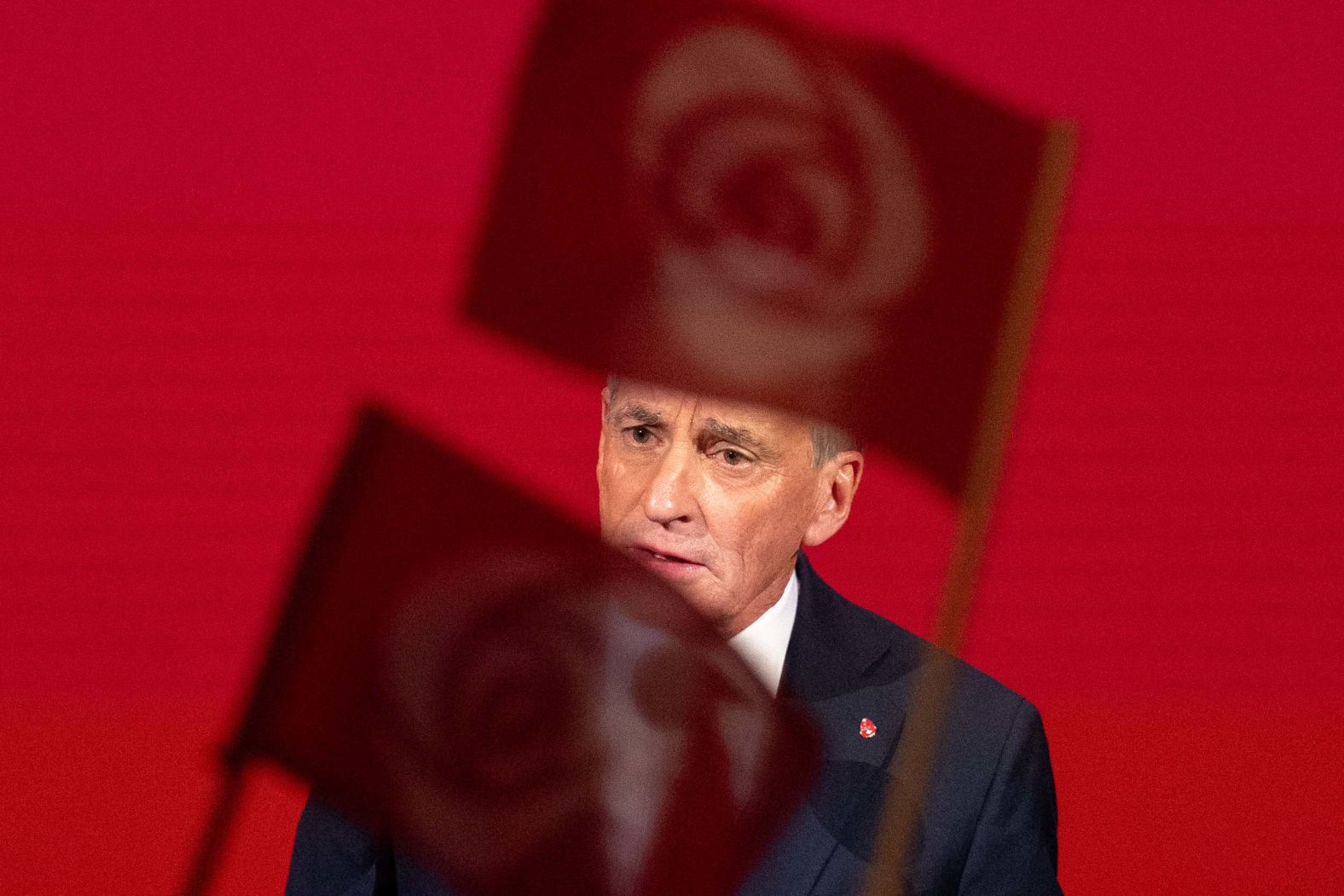 People wave party flags as Norwegian Prime Minister Jonas Gahr Støre addresses supporters in Oslo, Norway, on Monday, September 8. Støre’s Labour Party had just won the most seats in the latest parliamentary election.