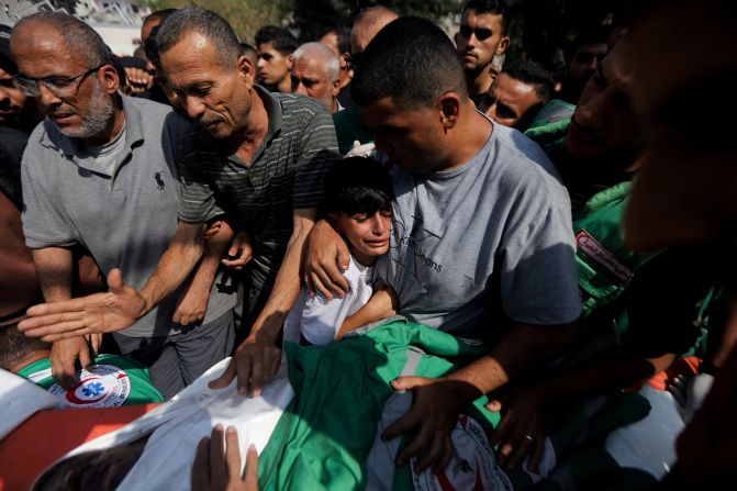 People in Gaza City attend funerals Tuesday, June 10, for a Palestinian journalist and three Palestinian medics who were killed in an Israeli airstrike, according to the Gaza Ministry of Health.