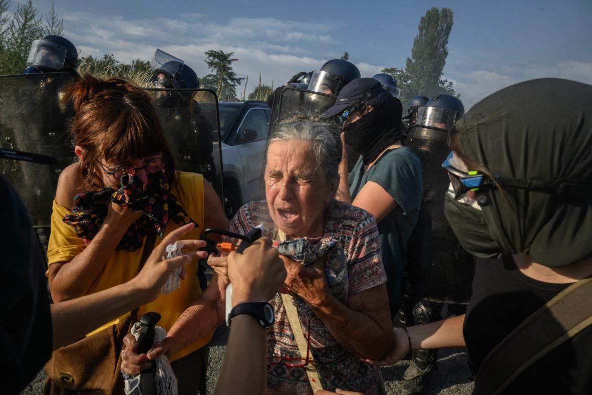 People protesting against the A69 motorway project react to tear gas as they clash with police in Maurens-Scopont, France, on Saturday, July 5.