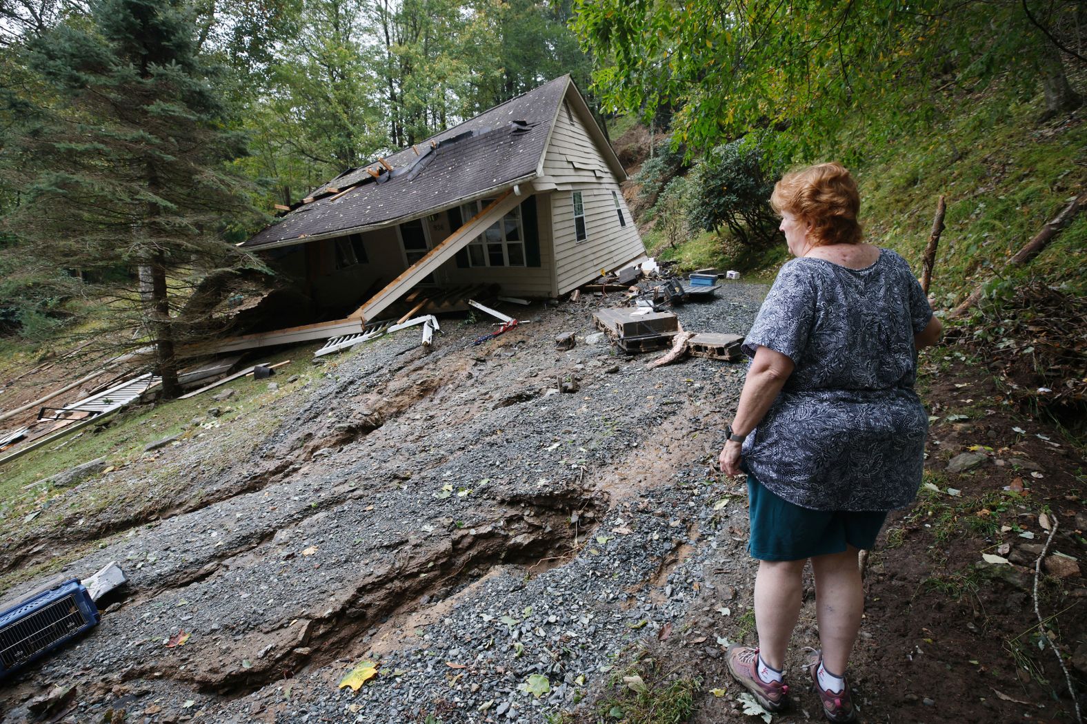 Meta Gatschenberger surveys the remains of her collapsed house in Boone, North Carolina, on Saturday, September 28.