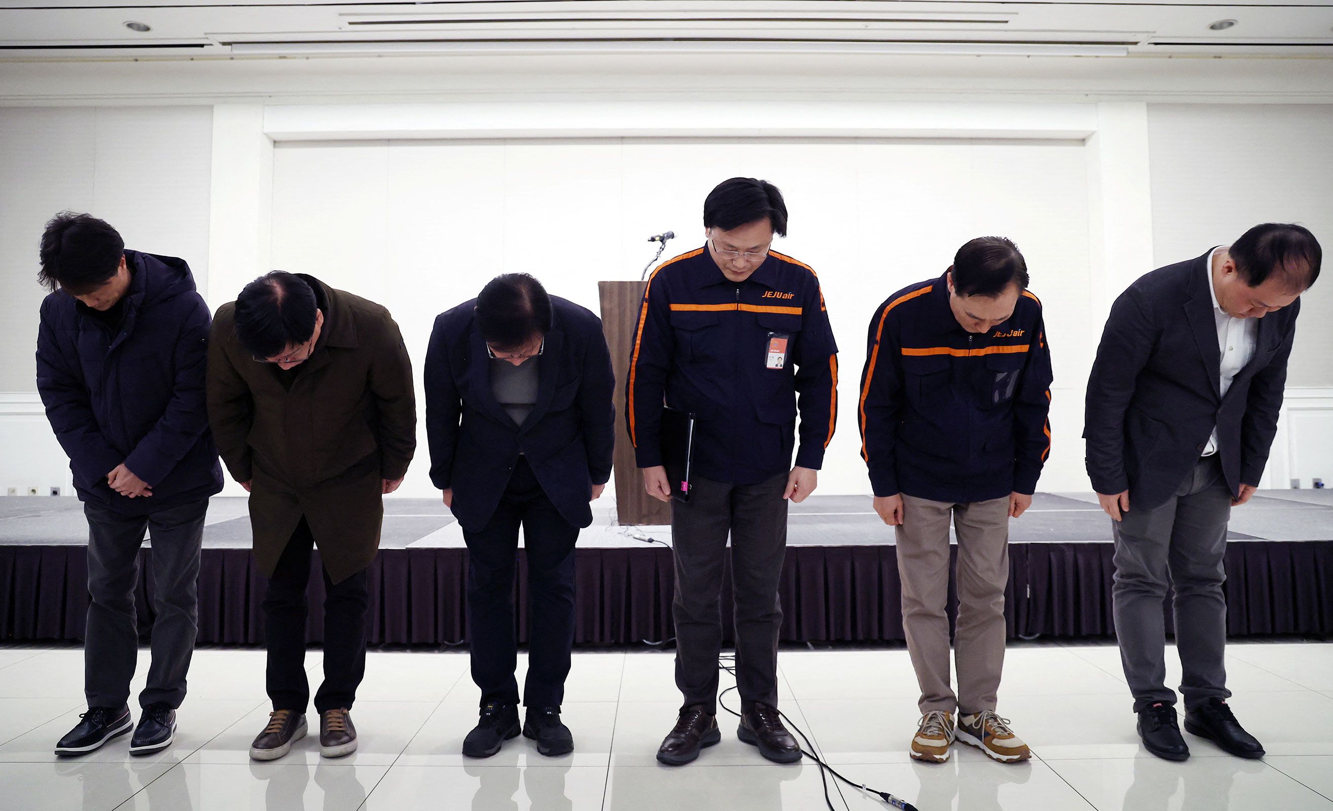 Jeju Air CEO Kim E-bae and others bow in apology for the plane crash during a press conference at Muan International Airport on December 29.