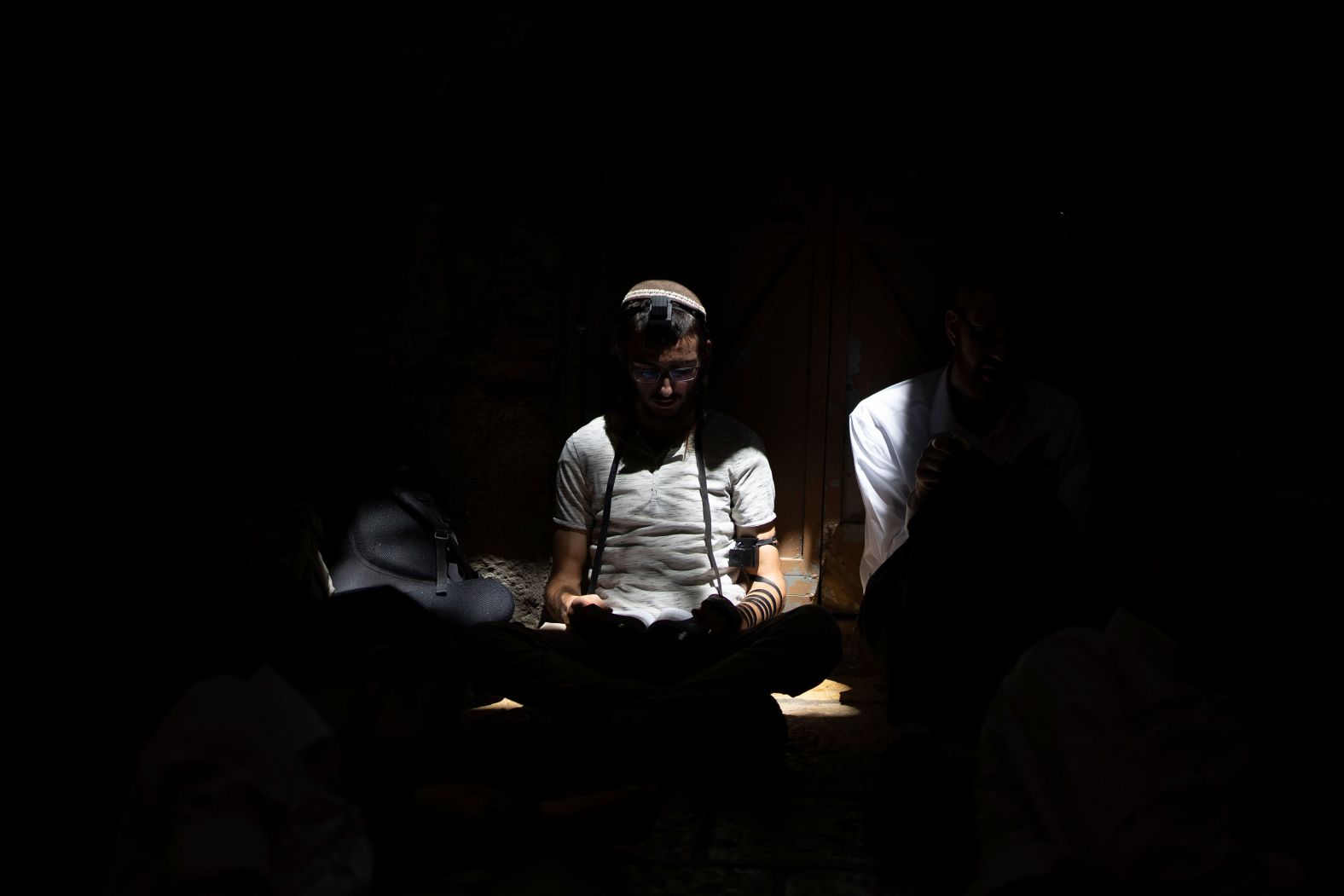 An ultra-Orthodox Jewish man prays during the mourning ritual of Tisha B'Av in the Old City of Jerusalem on Tuesday, August 13. The holy day marks the destruction of biblical temples.