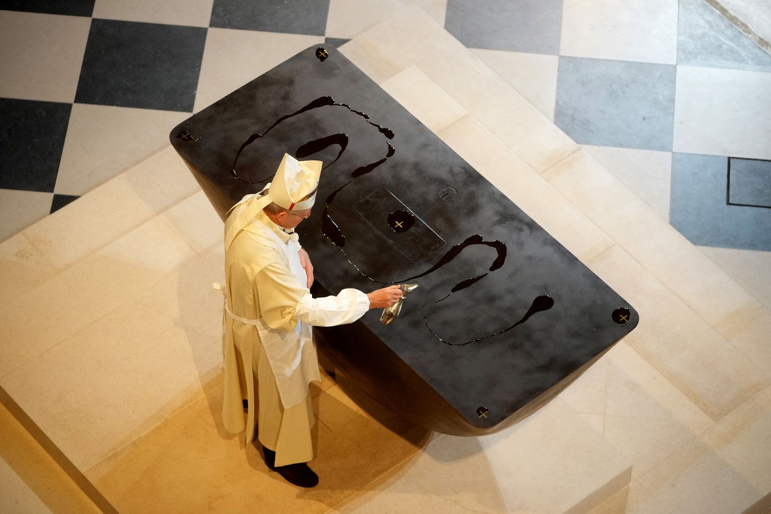 Archbishop Ulrich spreads holy oil on the altar on December 8.