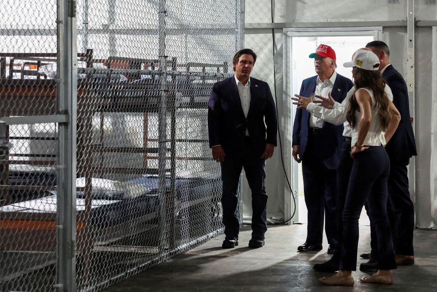 President Donald Trump, Florida Gov. Ron DeSantis and Homeland Security Secretary Kristi Noem visit a temporary migrant detention center informally known as