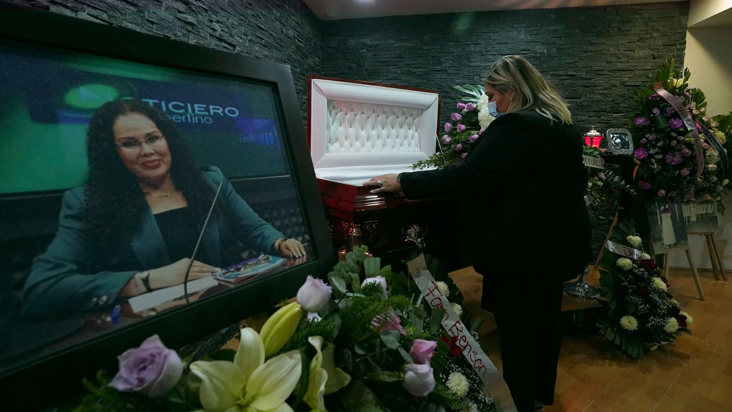 Renee Maldonado looks at the body of her aunt, murdered journalist Lourdes Maldonado during her wake at the Gayosso funeral home in Tijuana, Mexico, Wednesday, Jan. 26, 2022. (AP Photo/Marco Ugarte)