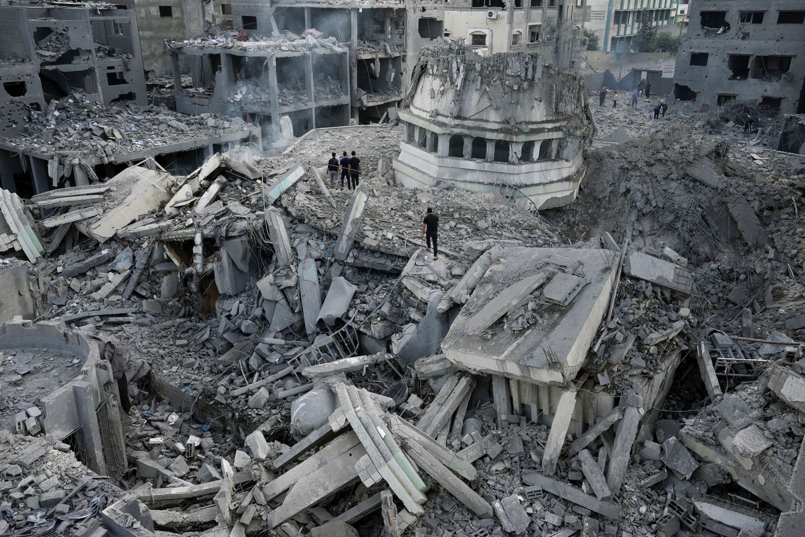 Palestinians inspect the rubble of the Yassin mosque on October 9 after it was hit by an Israeli airstrike at the Shati refugee camp in Gaza City.