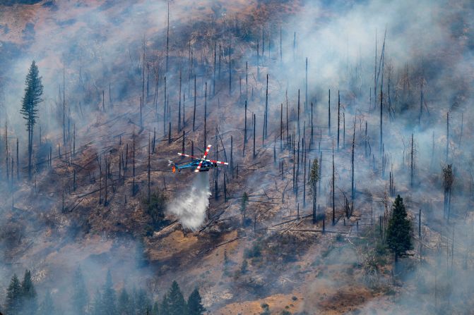 A helicopter drops water on the Park Fire near Butte Meadows, California, on July 30, 2024.