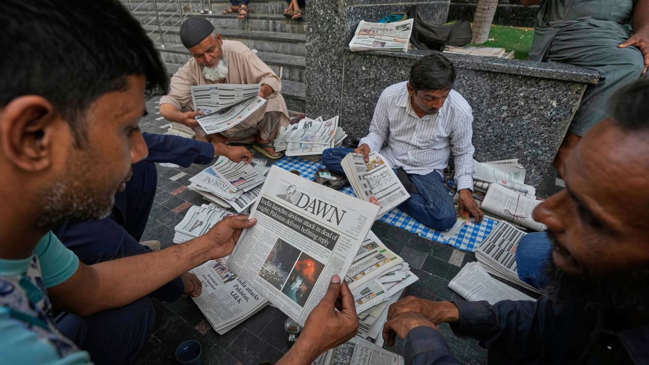 People read morning newspapers leading with the story of India firing missiles into Pakistani territory, in Karachi, Pakistan, Wednesday, May 7, 2025. (AP Photo/Fareed Khan)