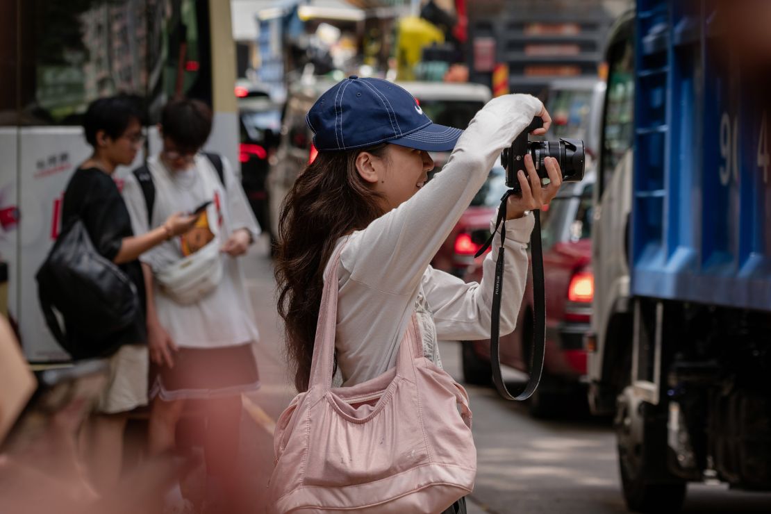 A woman takes pictures at an iconic Xiaohongshu spot in Hong Kong.