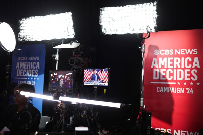 Trump is seen on a screen in the spin room on Tuesday.