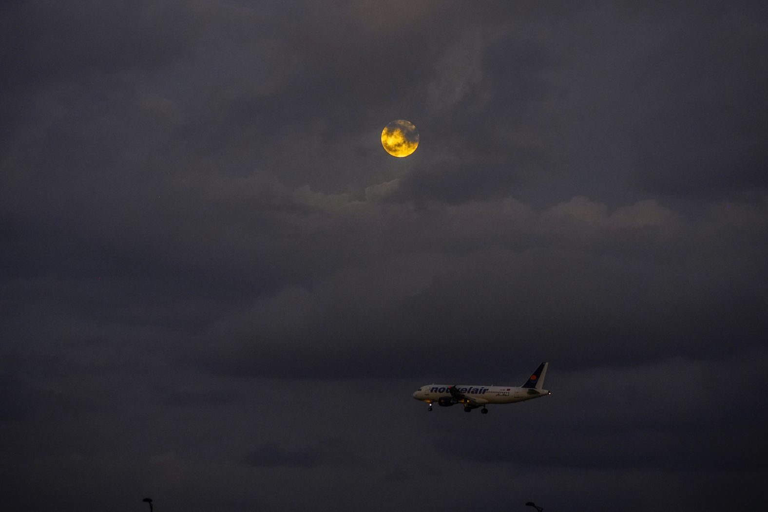 The beaver moon appears behind the clouds in Tunis, Tunisia.