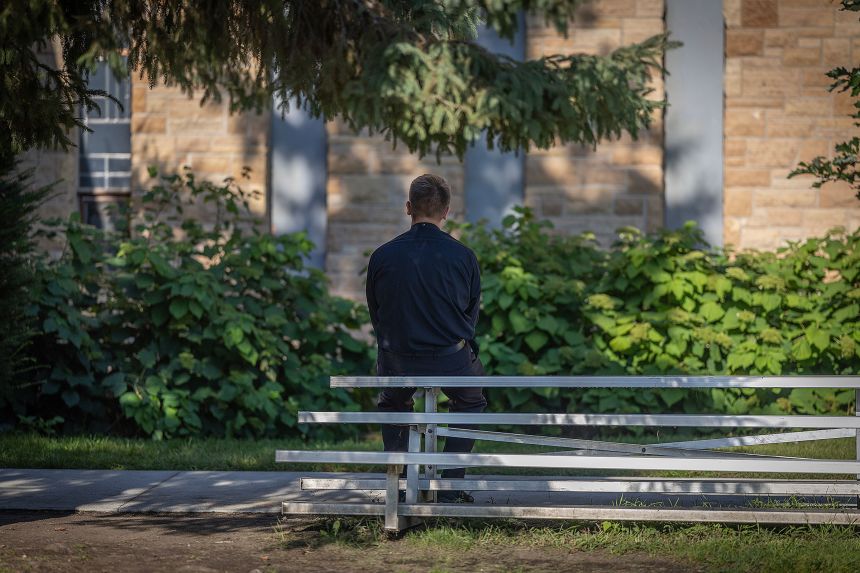 Deacon Peter Romans prays the rosary in front of the boarded up windows at Annunciation Catholic Church on Thursday.