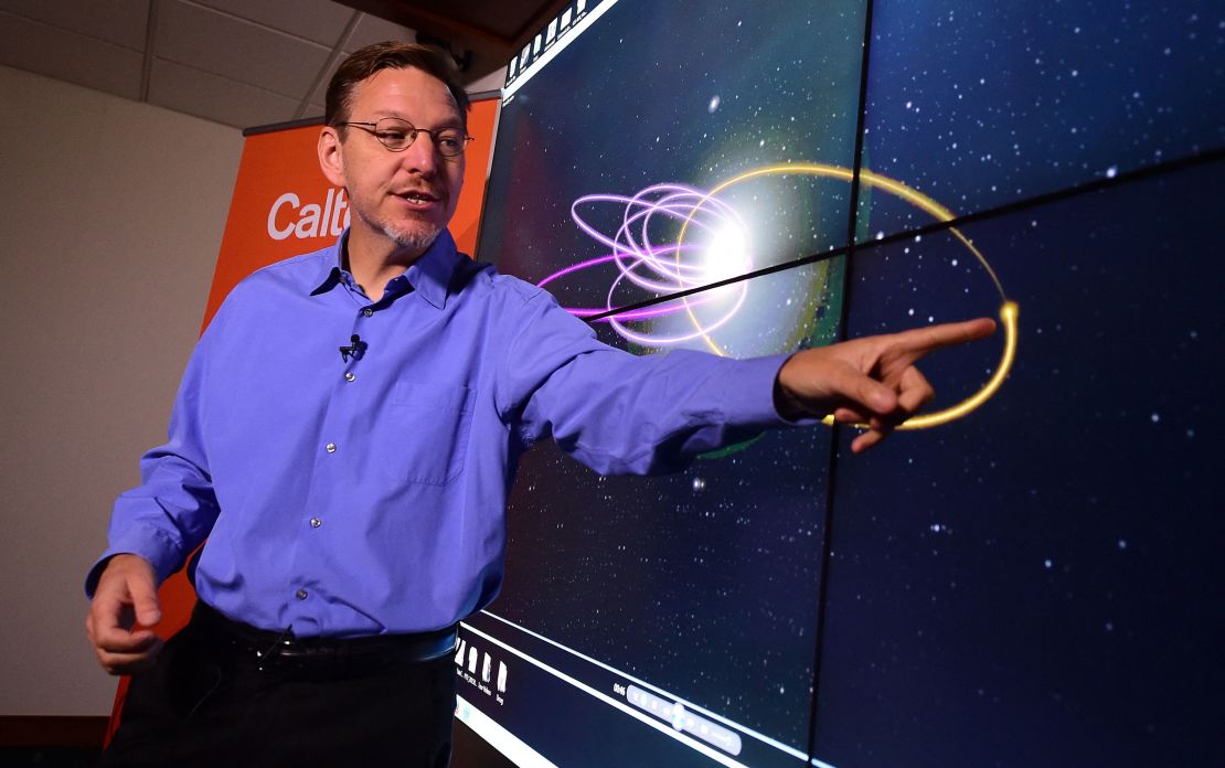 Caltech astronomer Mike Brown points out the "predicted orbit," in yellow, of the theorized Planet Nine while speaking at Caltech Seismology Lab in Pasadena, California, on January 20, 2016. Brown and his colleague, planetary scientist Konstantin Batygin, reported having strong evidence of a hidden planet on the fringes of our solar system.