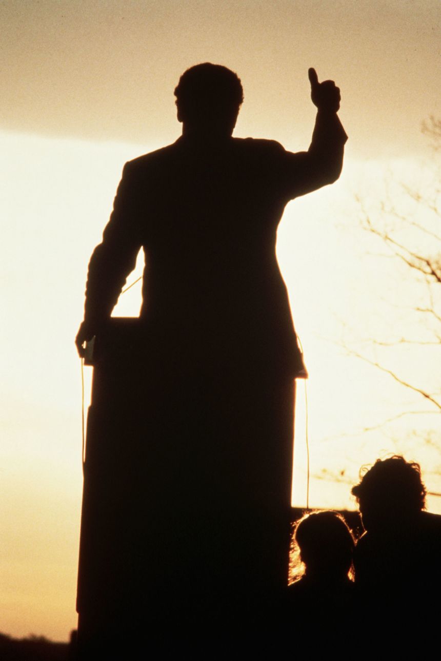 The low sun silhouettes Jesse Jackson as he gives the thumbs up sign during a campaign speech in Madison, Wisconsin.