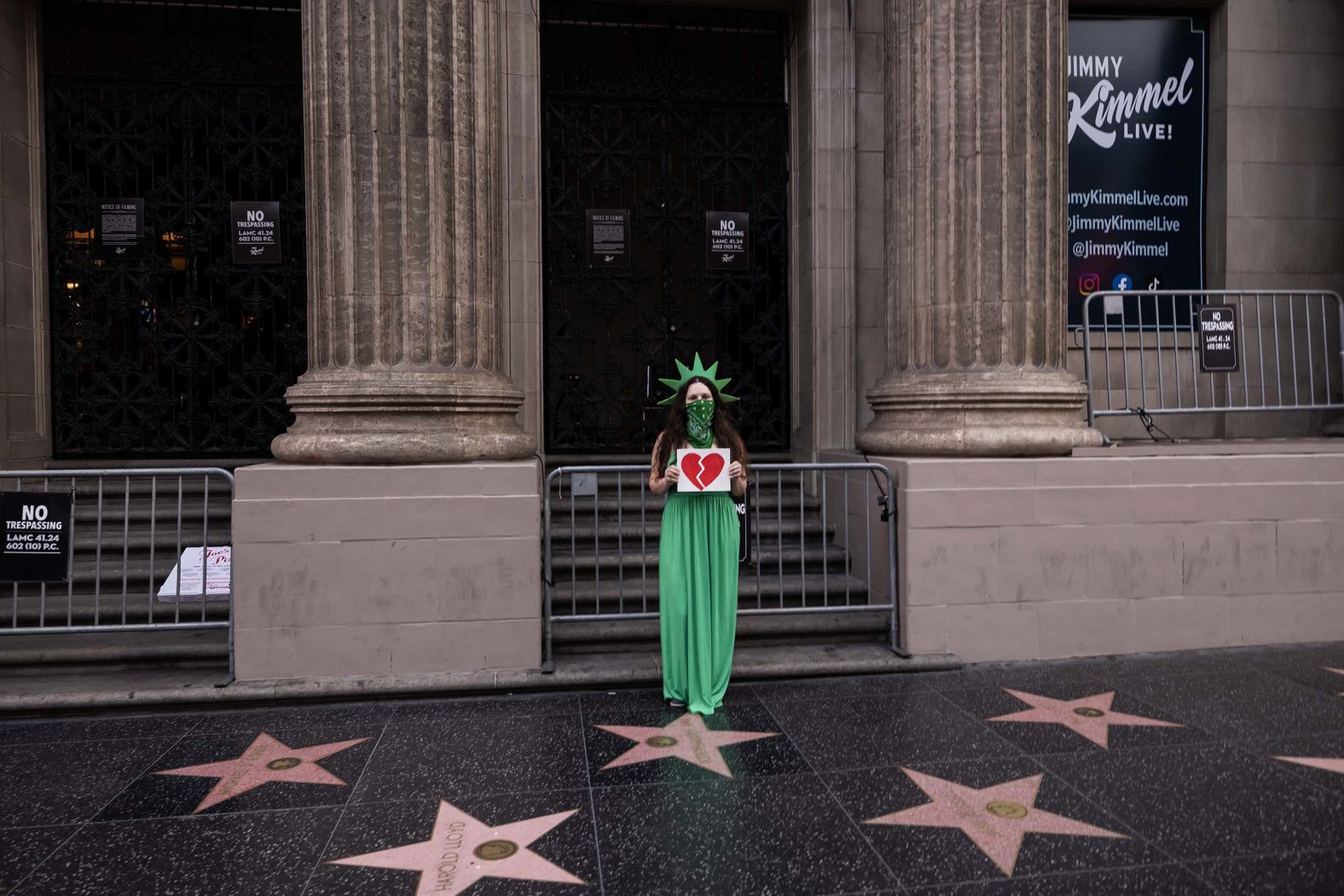A protester poses in front of the “Jimmy Kimmel Live!” studios in Los Angeles on Wednesday, September 17. Disney’s ABC <a href="index.php?page=&url=https%3A%2F%2Fwww.cnn.com%2F2025%2F09%2F17%2Fmedia%2Fjimmy-kimmel-charlie-kirk-trump-fcc-brendan-carr">took Kimmel’s late-night talk show off the air indefinitely</a> amid a controversy over his recent comments about Charlie Kirk’s suspected killer.
