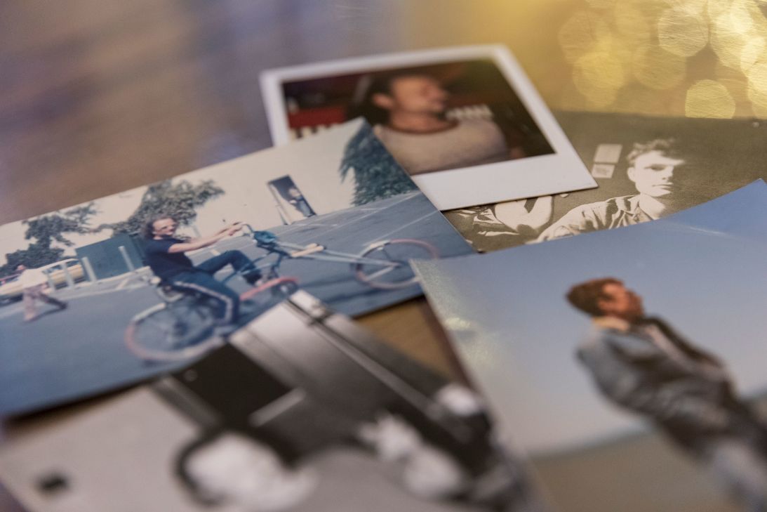 Photographs of Scott Janssen and his late uncle Eddie (on the bike) lay scattered on his dining room table in Chapel Hill.