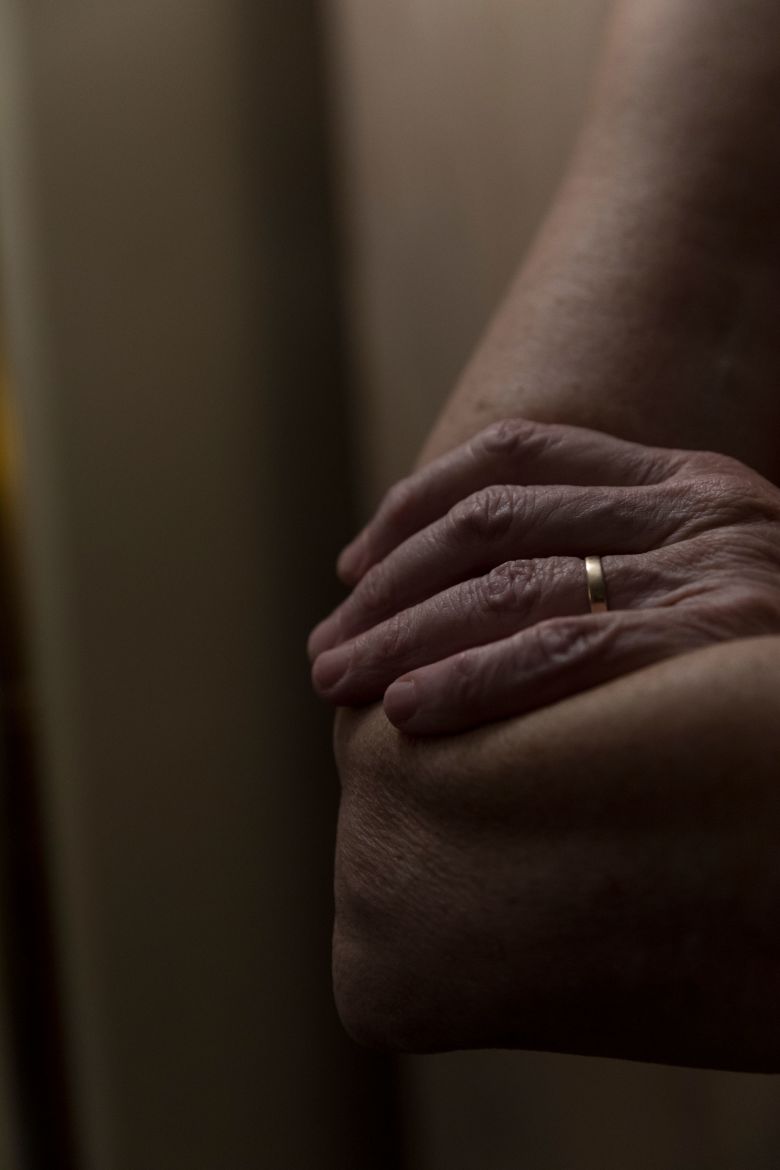 Sarah Janssen, Scott's wife, rests her hand on her arm. She says her husband's work has 