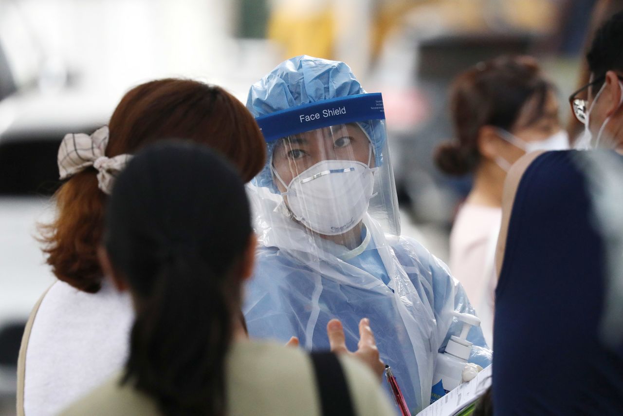 A medical worker screens for Covid-19 at a testing facility on August 26, in Seoul, South Korea. 