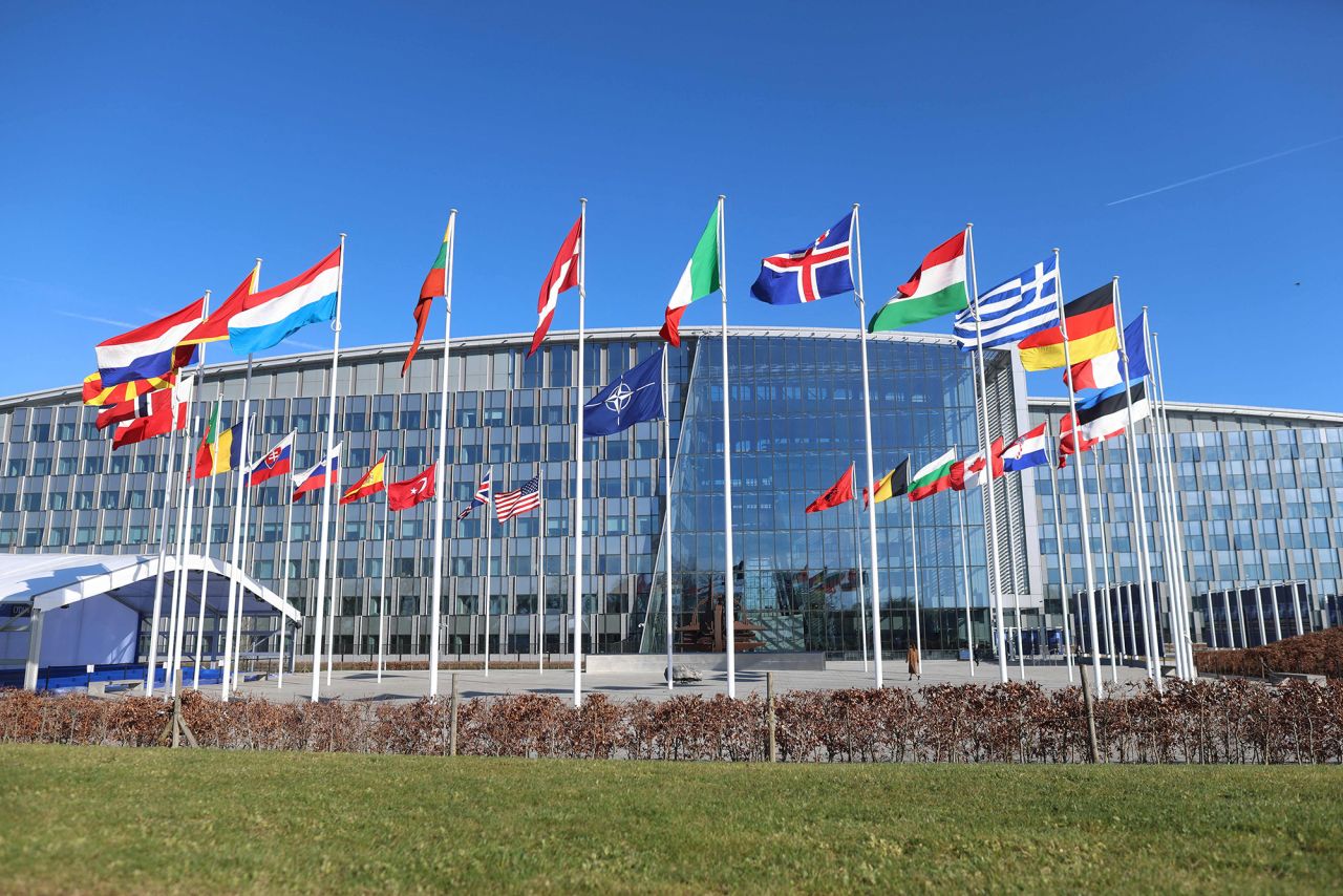 Member country flags with one empty mast ahead of a flag-raising ceremony for Finland's accession to NATO, in the Cour d'Honneur of the NATO headquarters in Brussels, Belgium, on April 4.