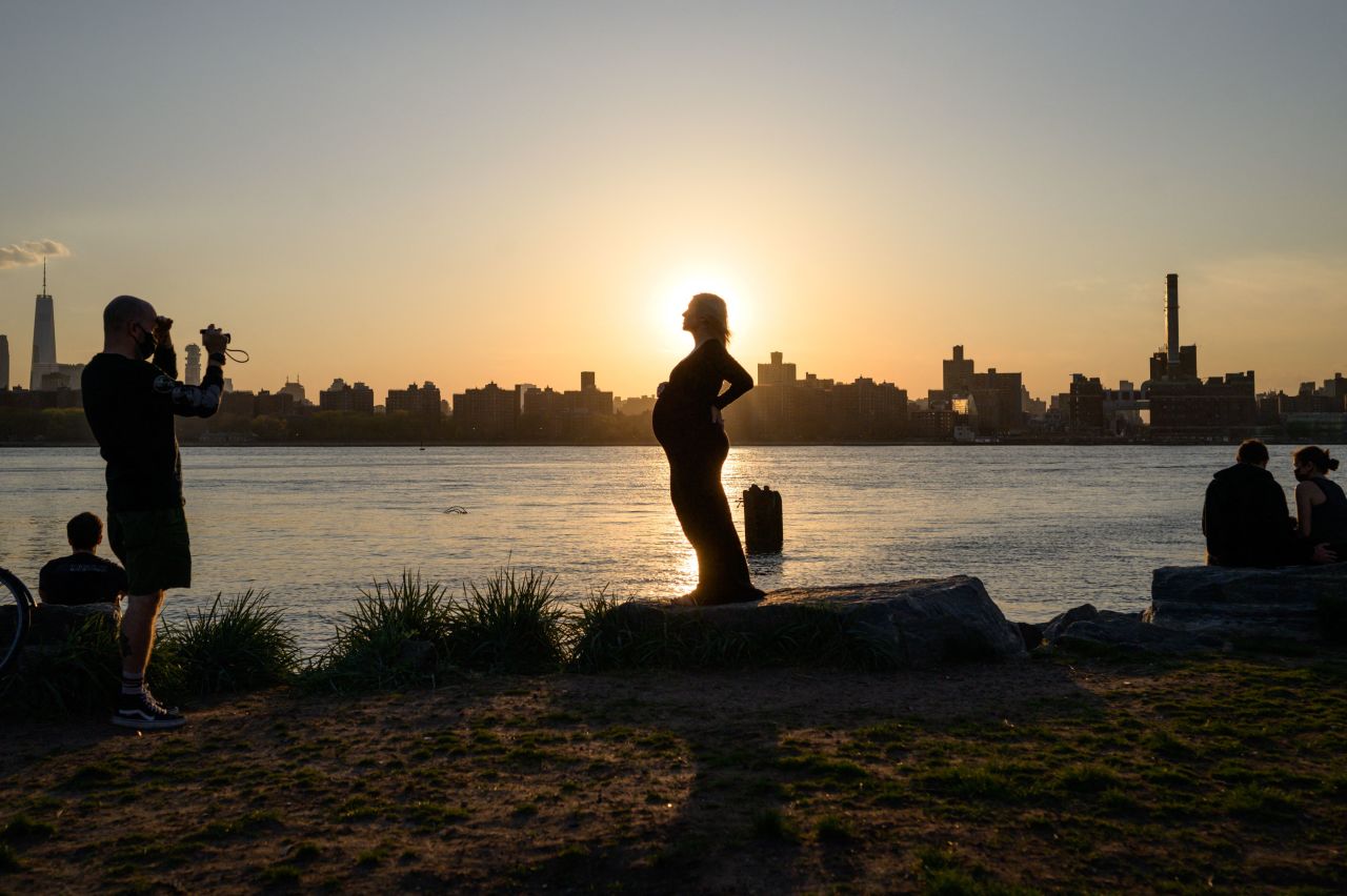 A pregnant person poses for photos in Williamsburg, New York, on Friday, April 20.