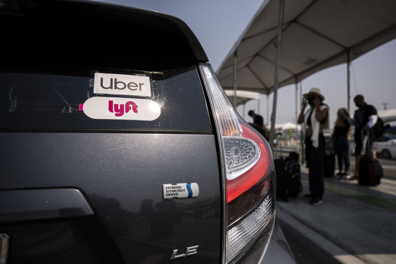 Uber and Lyft stickers are displayed on a car at Los Angeles International Airport in California on August 20.