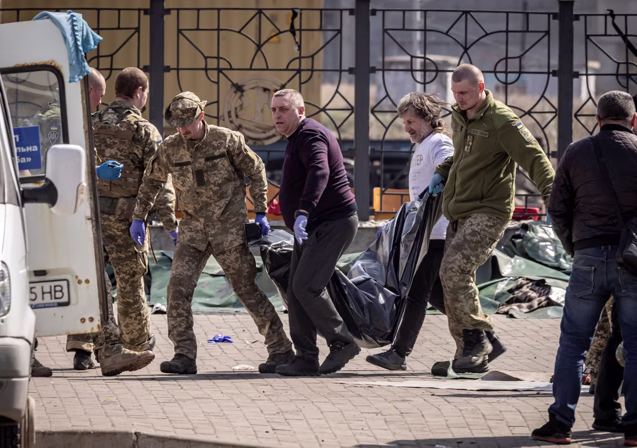 Ukrainian soldiers move bodies after a rocket attack at a train station in Kramatorsk, Ukraine on April 8. 