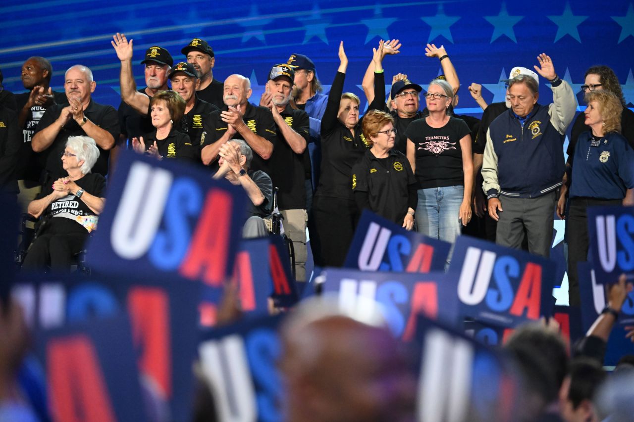 People cheer as Teamster union members take the stage at the convention on Tuesday.?