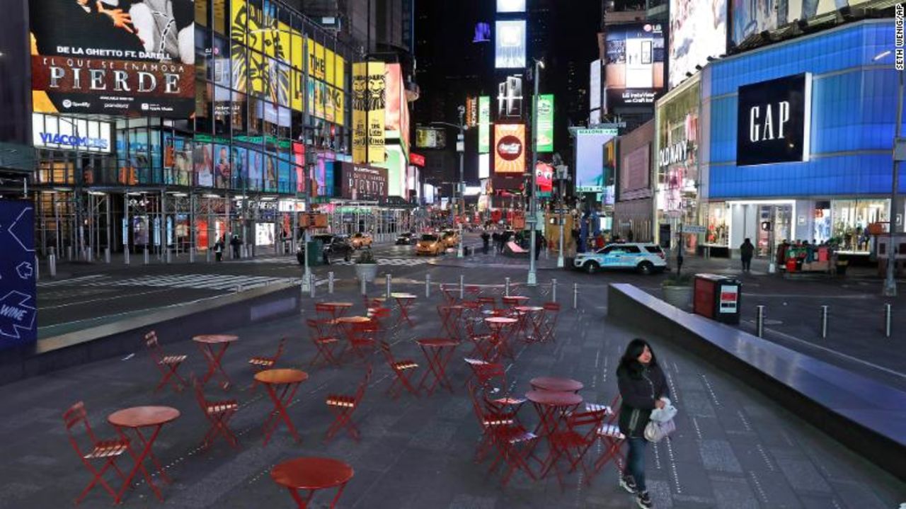 A woman walks through a lightly trafficked Times Square in New York on Monday.