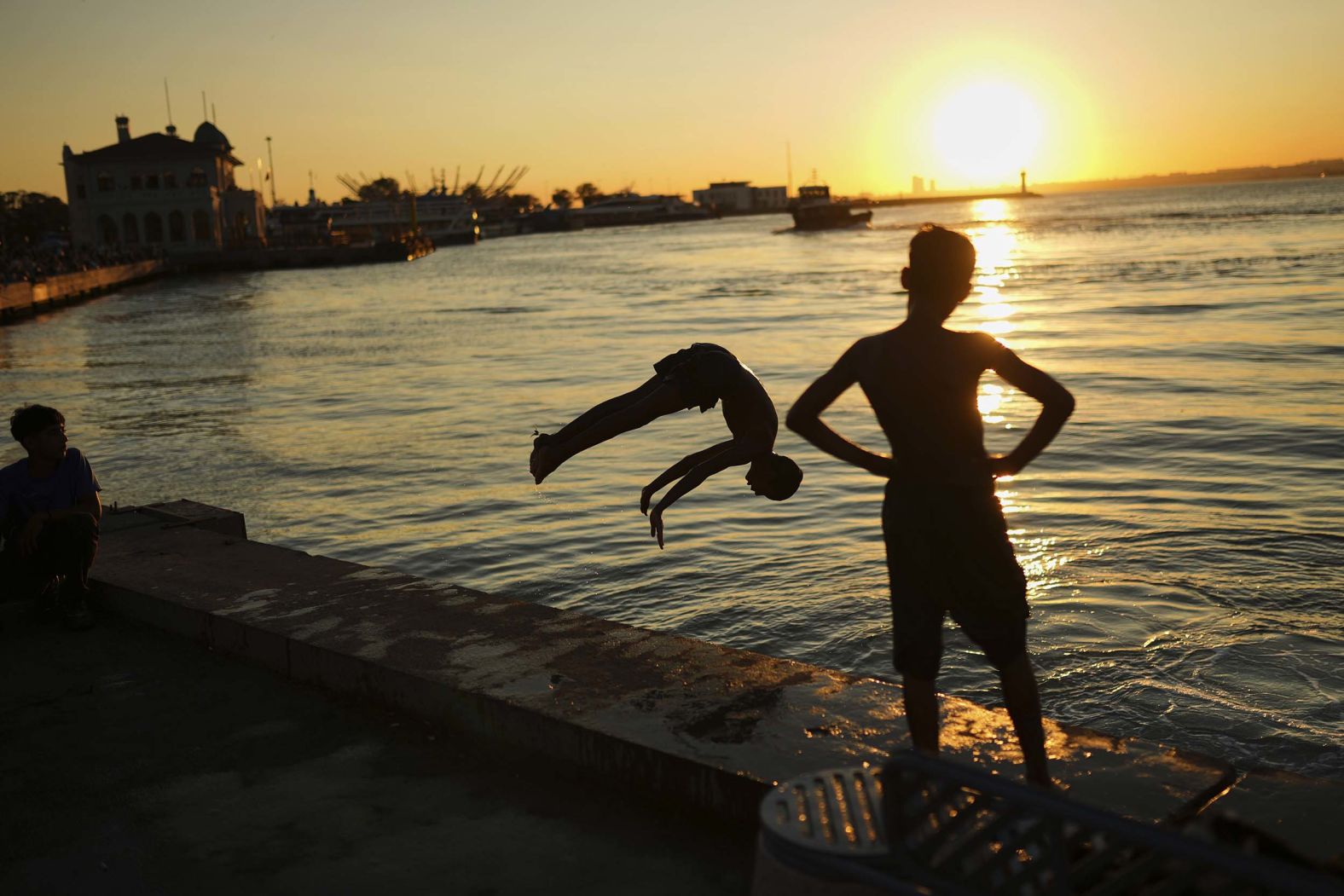 Children dive into the Bosphorus at the Kadıköy sea promenade in Istanbul on Tuesday, September 16.