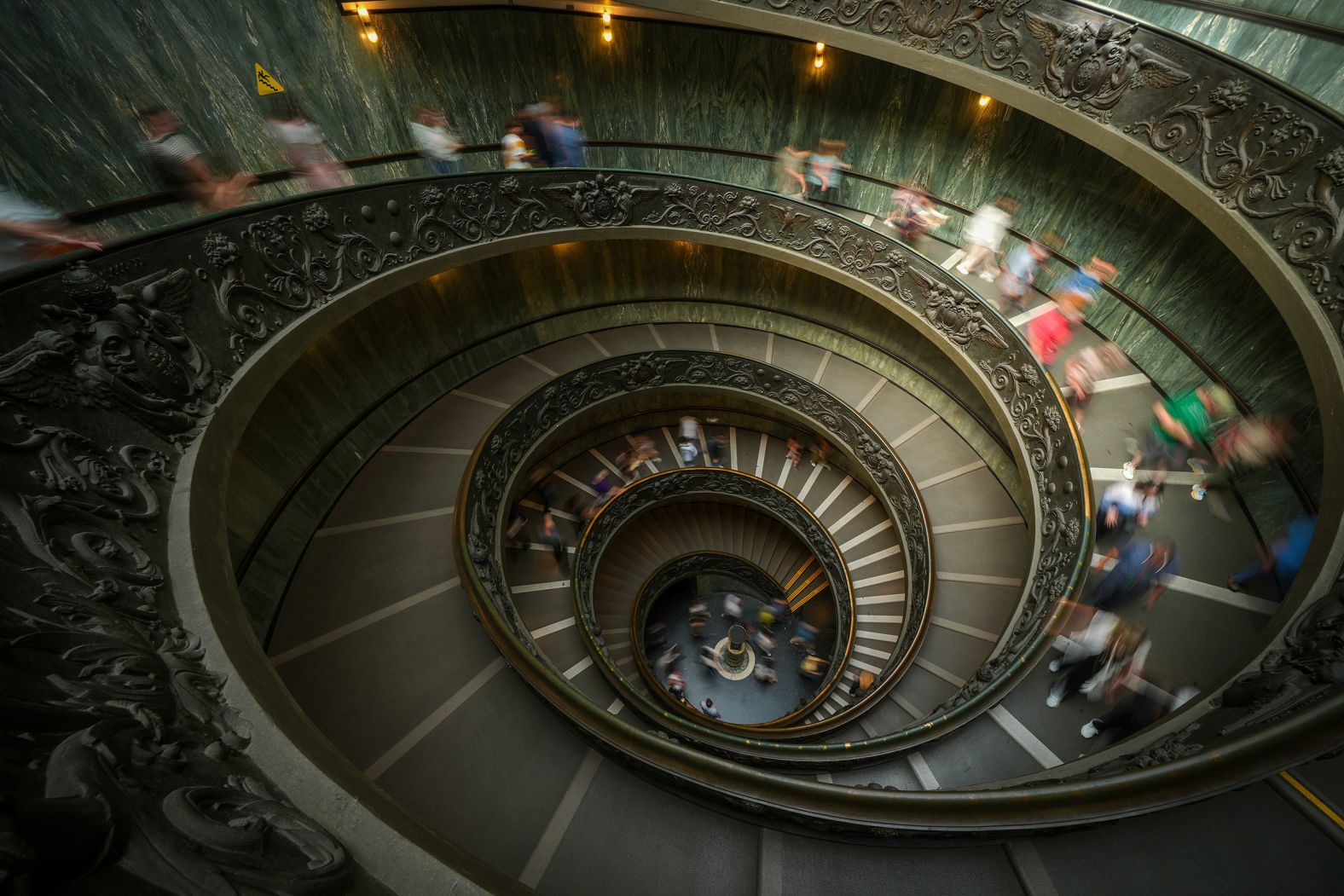 People walk on the double-helix Bramante staircase in the Vatican Museum on Friday, May 2.