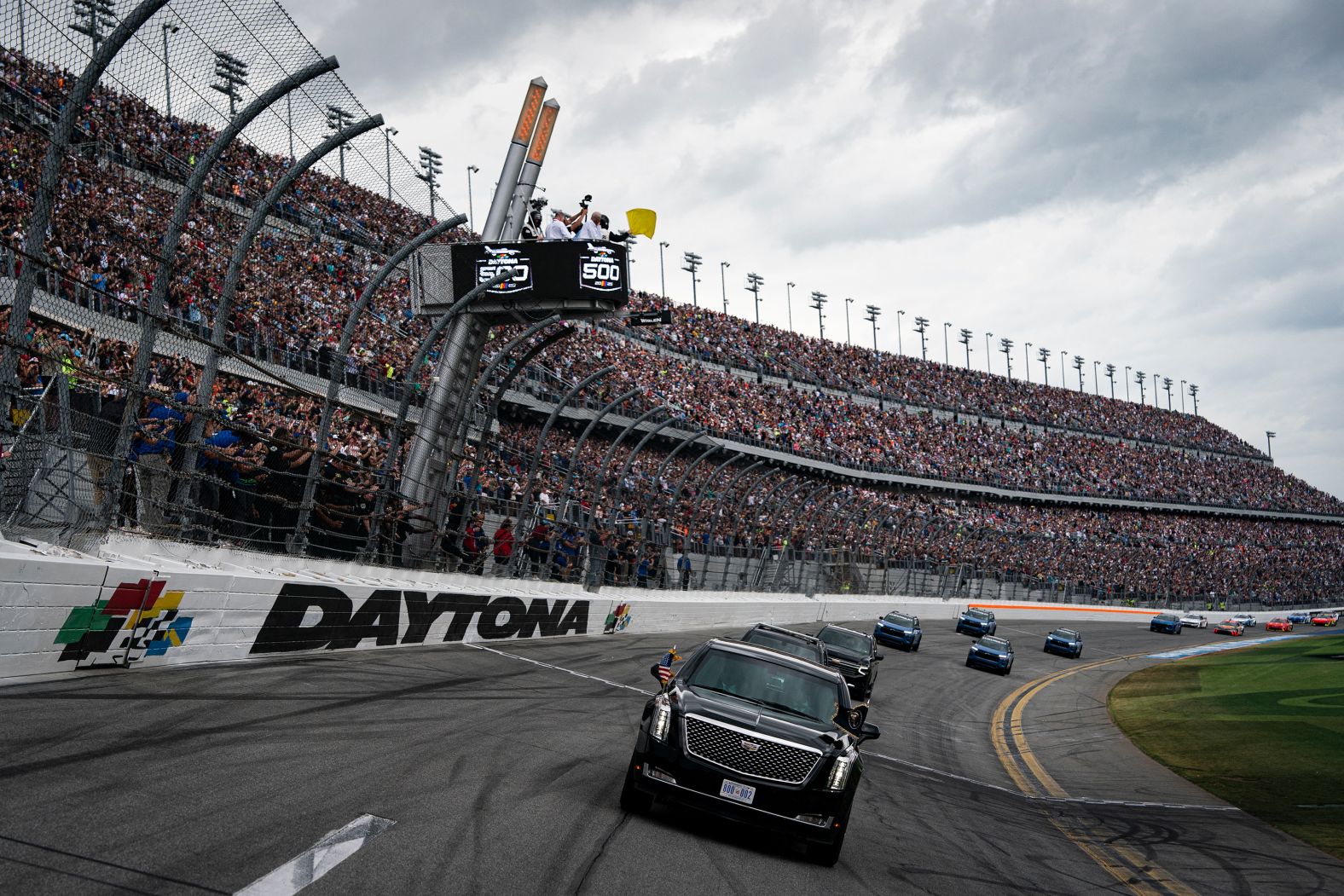 US President Donald Trump rides in the presidential limousine during a pace lap that took place before the Daytona 500 on Sunday, February 16.