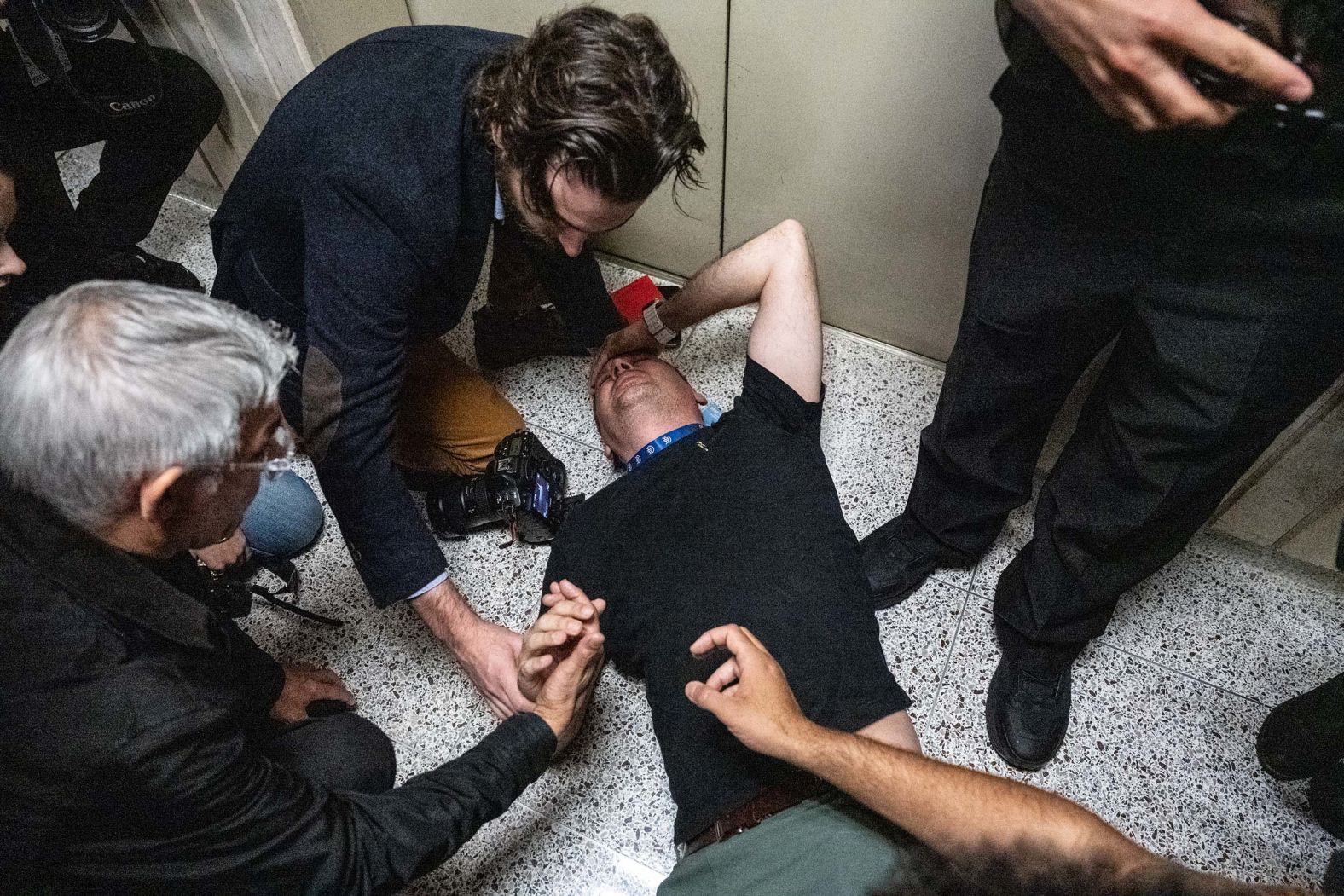 L. Vural Elibol, a videographer for the Anadolu Agency, is tended to after being injured at an immigration courthouse in New York on Tuesday, September 30. Masked Immigration and Customs Enforcement agents were detaining a woman in an elevator when <a href="index.php?page=&url=https%3A%2F%2Fwww.cnn.com%2F2025%2F09%2F30%2Fus%2Fice-new-york-immigration-court-jounalists">journalists were shoved</a> and at least one was injured. The incident comes amid growing tensions over ICE tactics.