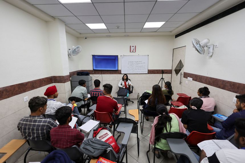 Students attend an International English Language Testing System class in Ambala, Haryana, India, in August 2022.