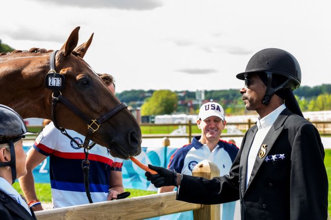 Rapper Snoop Dogg feeds a horse at an equestrian event on August 3.