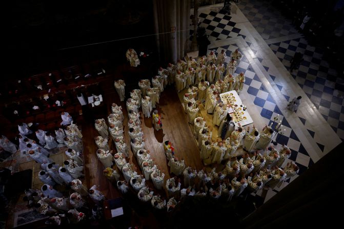 Archbishop Ulrich, surrounded by clergy members, leads the Eucharist on December 8.