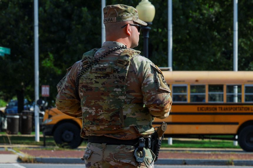 A member of the Louisiana National Guard carries his sidearm while patrolling in Union Station during the back-to-school season in Washington, DC, on August 25, 2025.