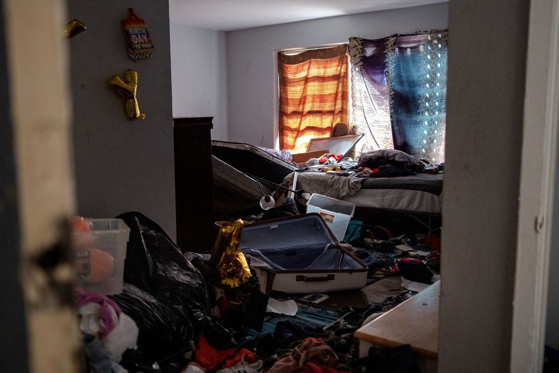 Debris and personal belongings sit on the floor of an empty apartment, in a Chicago complex where 37 people were detained during a large scale ICE raid, on September 30.