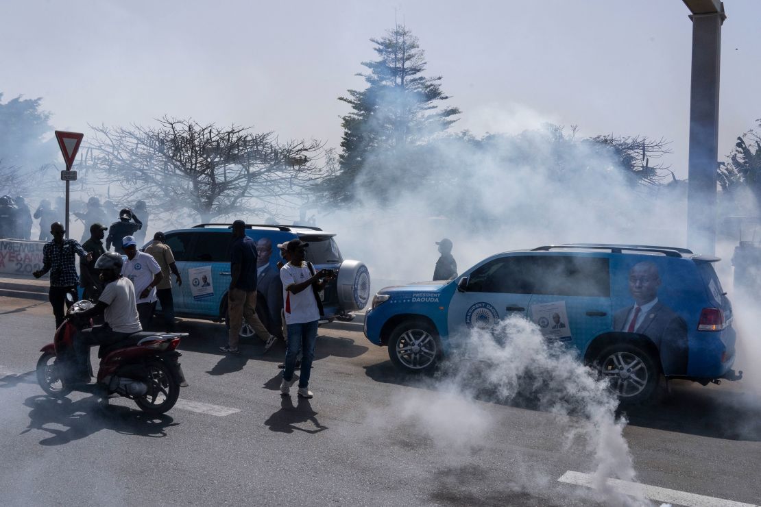 Senegalese riot police lobs tear gas at supporters of opposition presidential candidate Daouda Ndiaye in Dakar, Senegal, Sunday, Feb. 4, 2024.