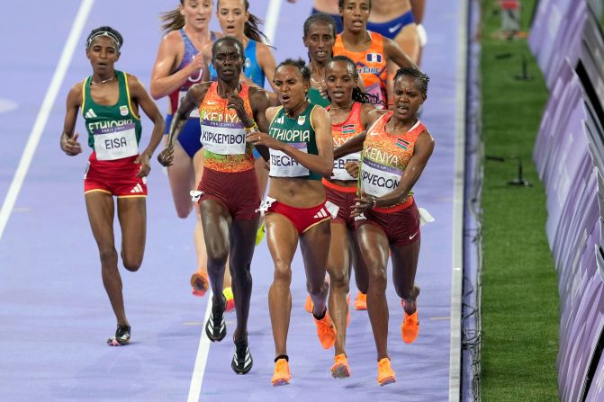 Kenya's Faith Kipyegon, right, fights for the lead during the 5,000-meter final on August 5. Kipyegon was initially disqualified, <a >but her silver medal was later reinstated</a>. Kenya's Beatrice Chebet won gold.