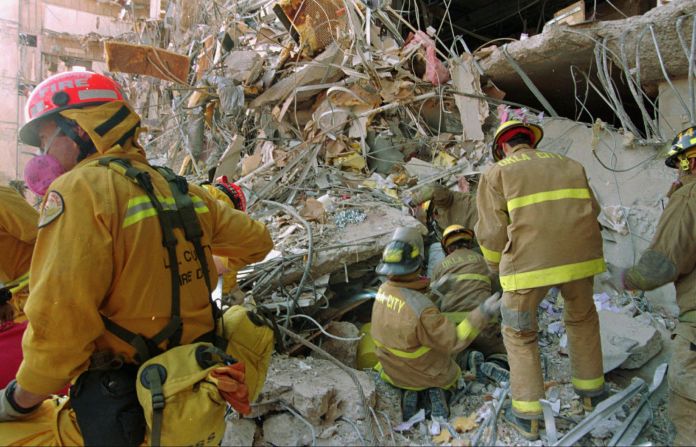 Rescue workers dig through debris.
