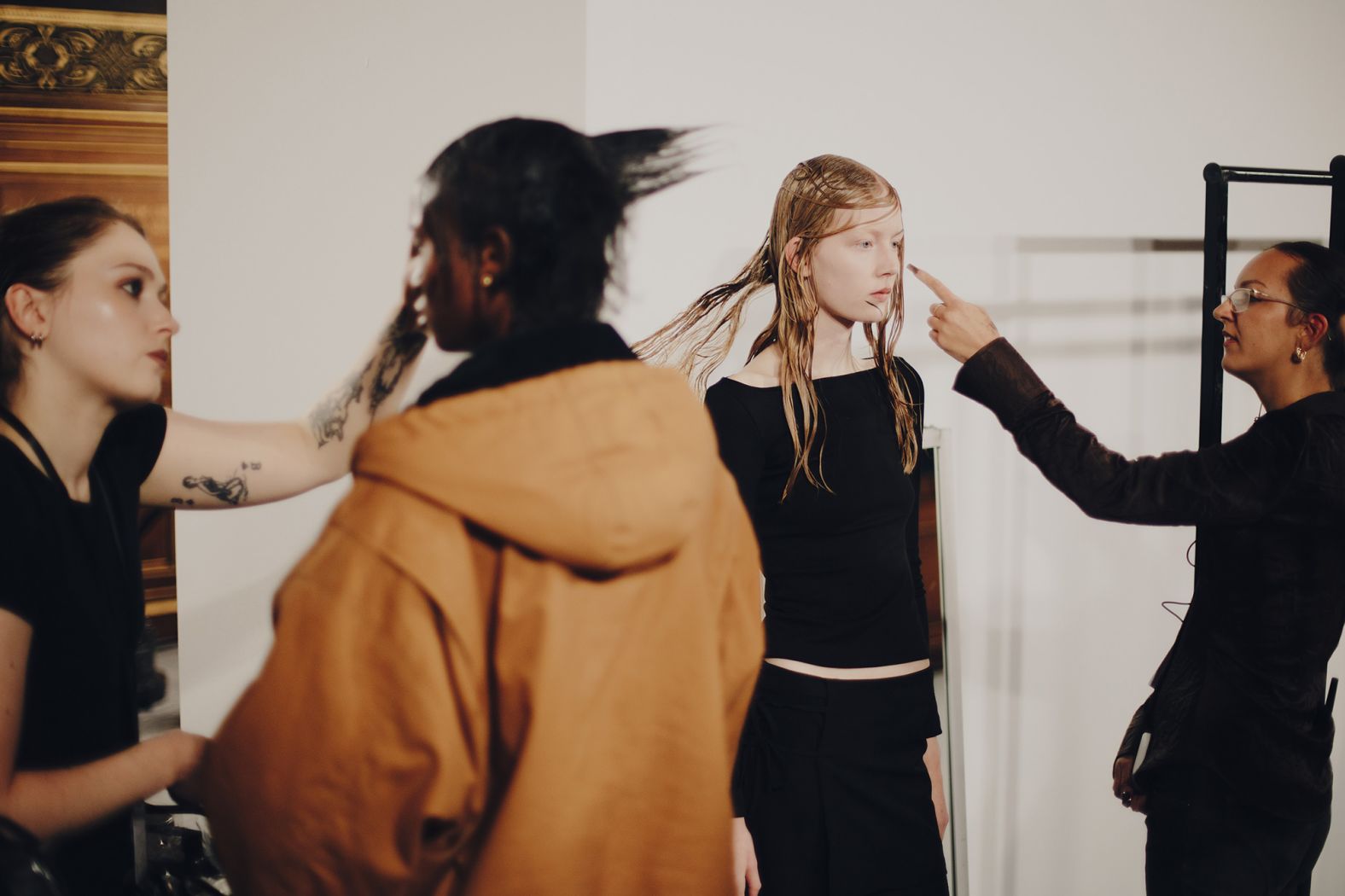 Models getting ready backstage at Yohji Yamamoto.