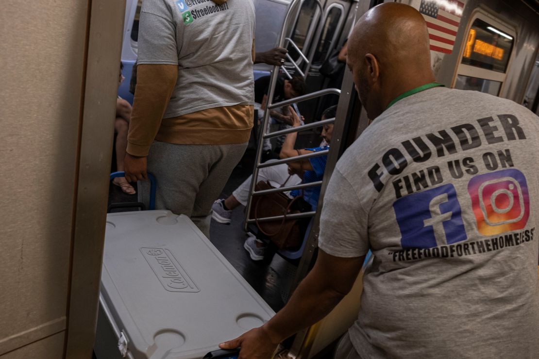 Henry and Carl Thomas wrestle their cooler onto a subway car.