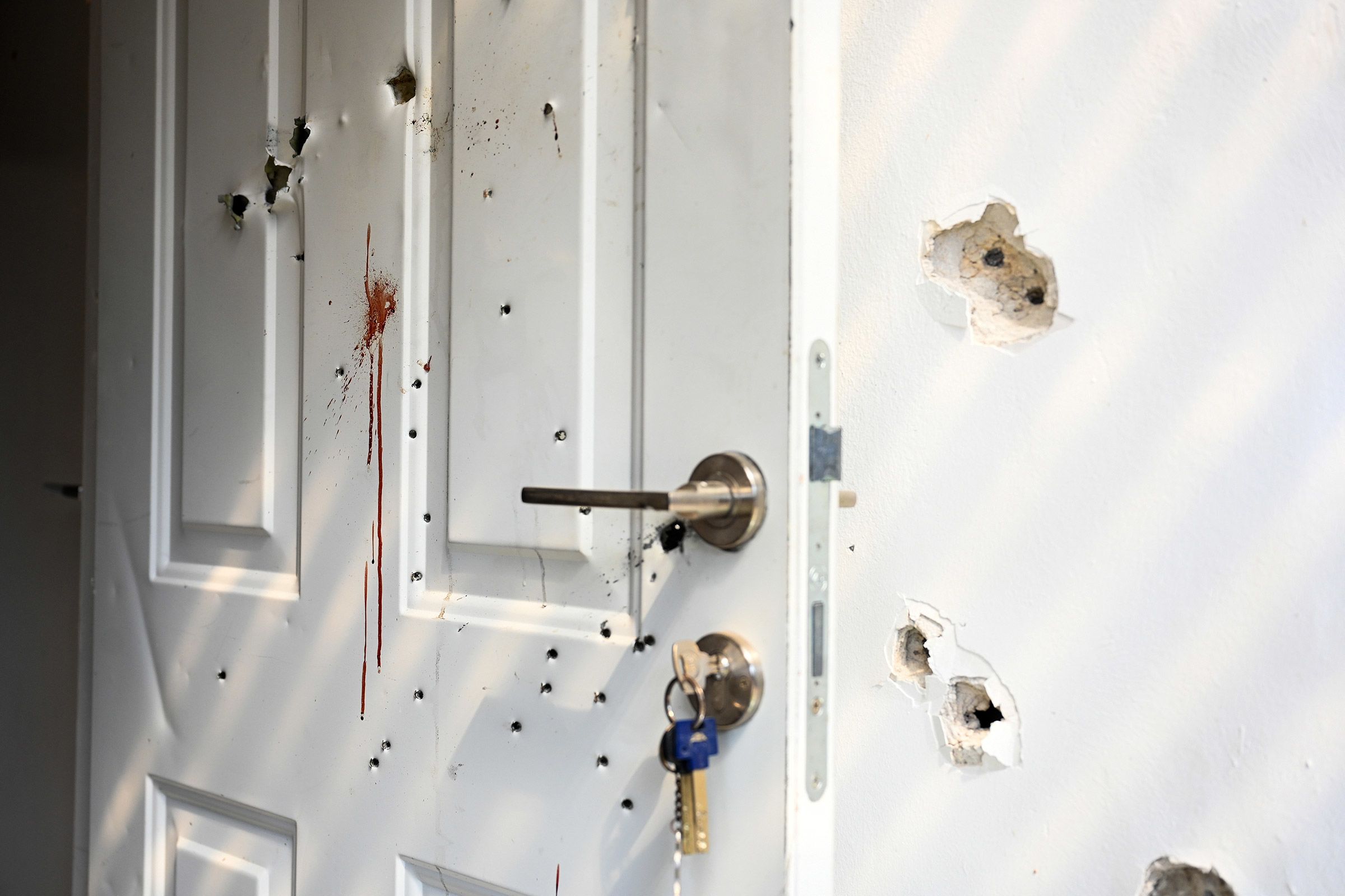 Gunshots and bloodstains are seen at a house in Kfar Aza, Israel, on October 10.