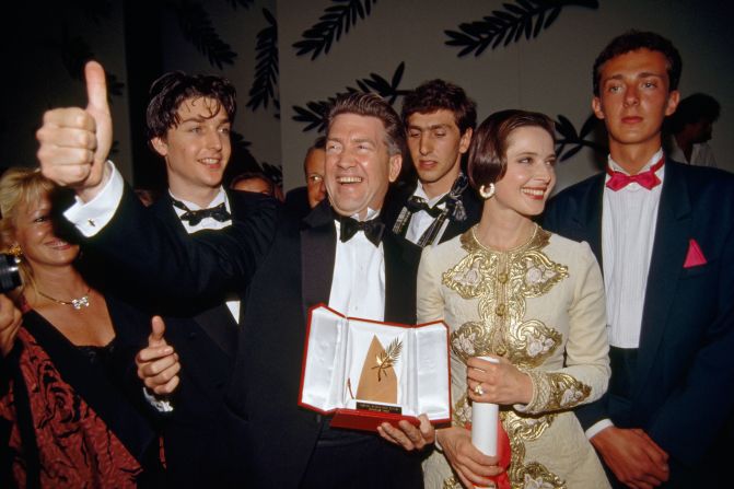 Lynch celebrates winning the Palme d'Or Award for "Wild at Heart" at the 1990 Cannes Film Festival. With him is actress Isabella Rossellini, who appeared in the film.