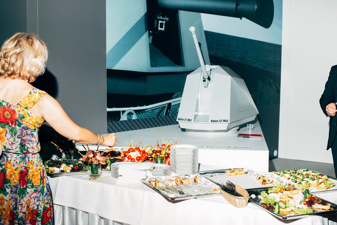 A model of a Swedish Bofors naval gun is the backdrop to a colorful buffet at the MSPO fair in Kielce, Poland in 2016.