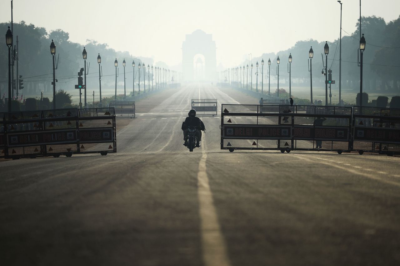 A motorist rides through a nearly empty road in New Delhi, India on March 22.