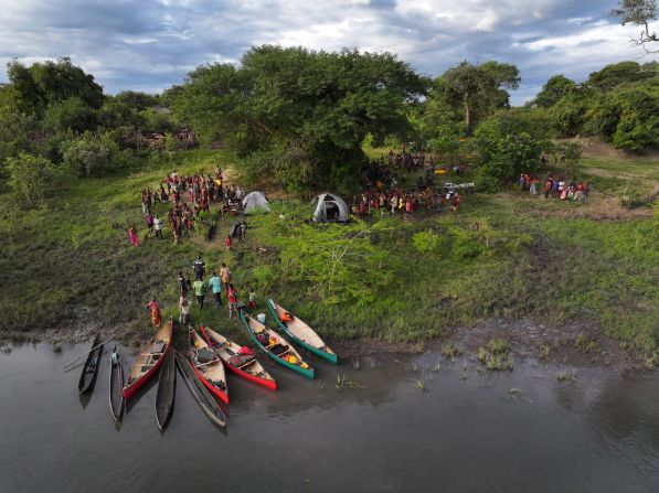 Pictured, the expedition team camp at a fishing village, attracting curious onlookers. Learning from local fishermen is an integral part of understanding the health of the catchment waters.